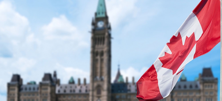 Canadian parliament building with Canadian flag