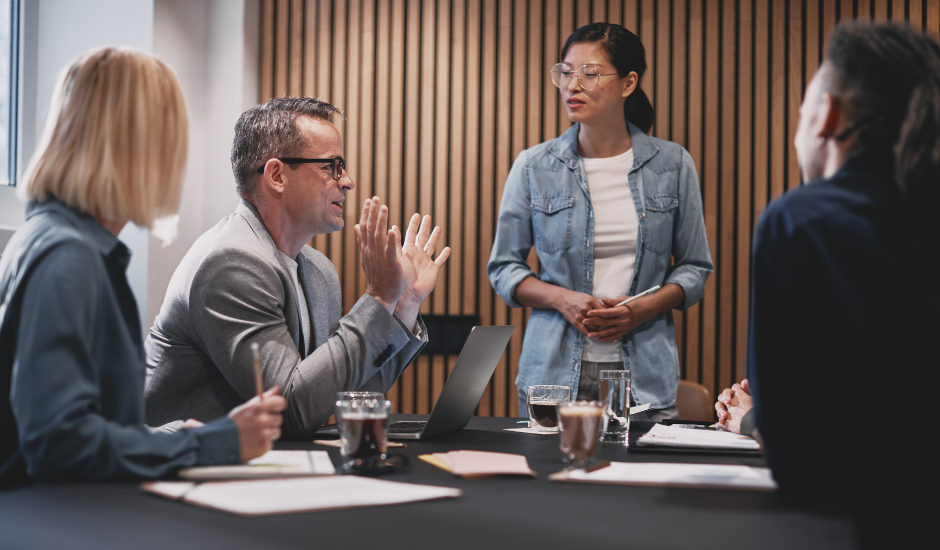 A diverse group of professionals having a discussion within an informal meeting room in Toronto, Ontario