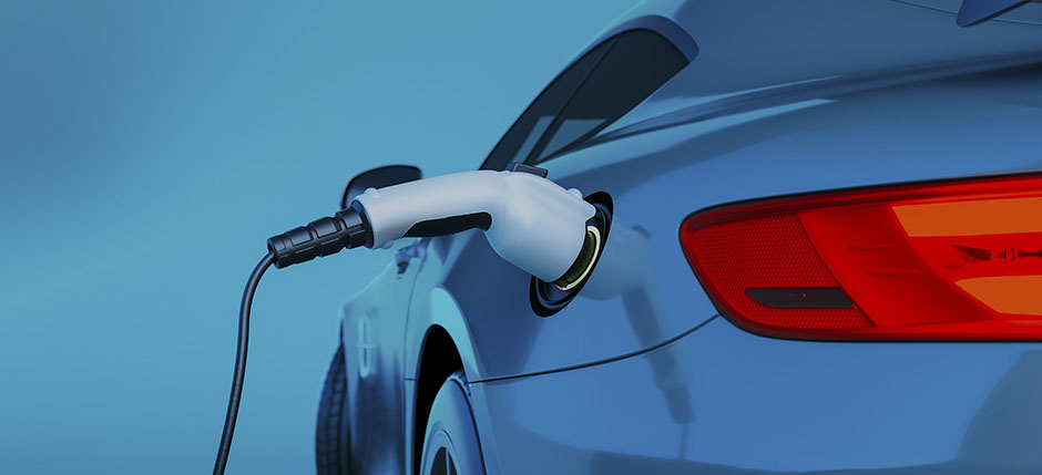 Blue electric vehicle hooked up to battery charger