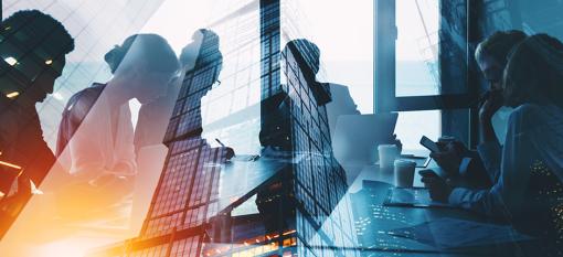 Silhouette of businesspeople working together in an office.